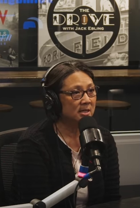 Dr. Janet Eng on The Drive radio show, wearing headphones at the microphone